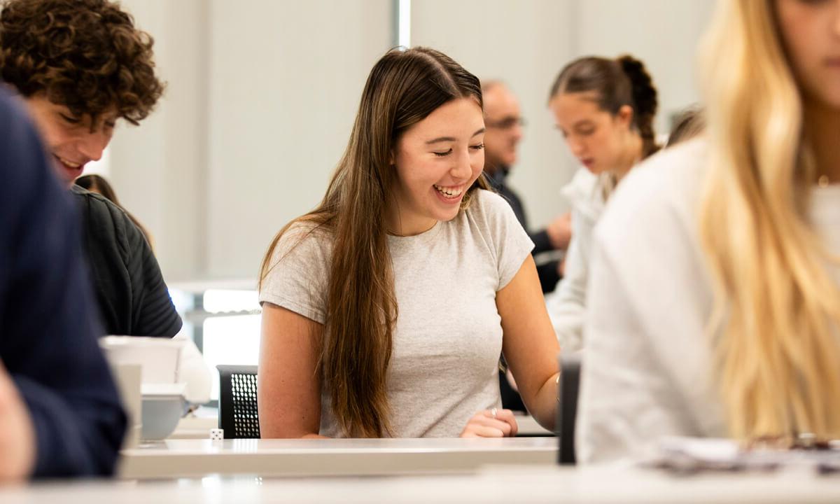 High school student smiling at a desk